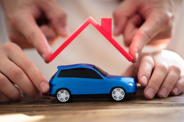 Human Hand Protecting Blue Car