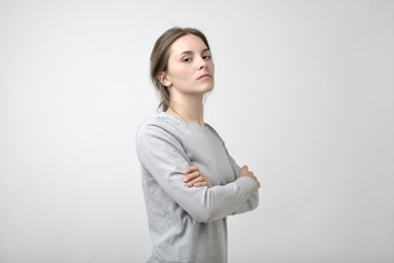The young woman portrait with proud and arrogant emotions on face.