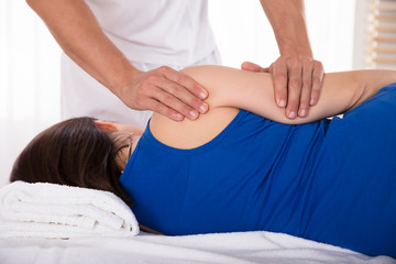 Rear View Of A Woman Receiving Massage