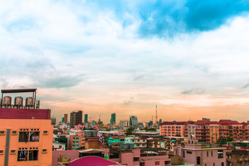 Bird view over cityscape with sun and clouds in the morning.Copy space.Bangkok.Pastel tone.