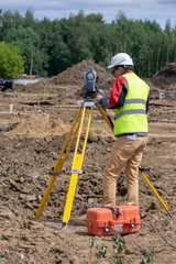The surveyor is shooting at a building site