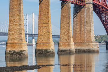 Forth Bridge Scotland and landing-stage for launches. In the background the Forth road bridge and Queensferry Crossing Bridge © Kruwt
