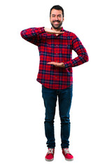 Fototapeta premium Handsome man holding copyspace imaginary on the palm