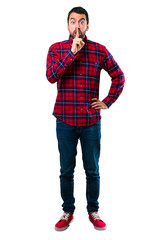 Fototapeta premium Handsome man showing a sign of closing mouth and silence gesture