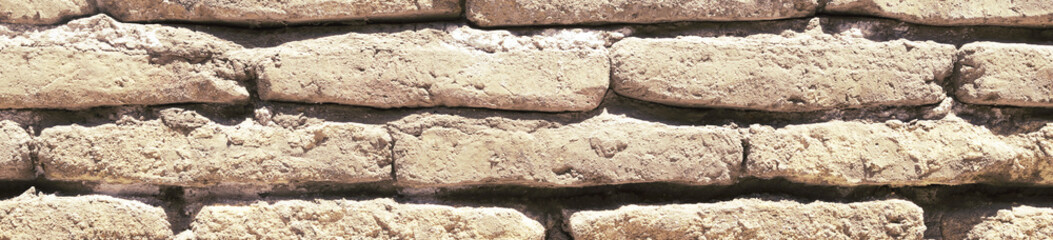 An ancient old rough drystone wall. Background photo. Texture pattern.