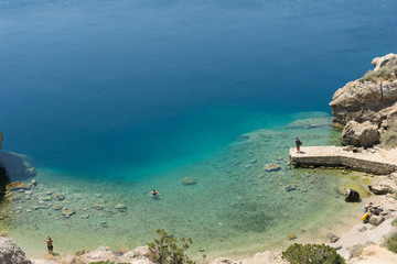 Blue crystal waters at a small beach near archaeological site of Heraion, sanctuary of goddess Hera, in Perachora, Loutraki, Greece