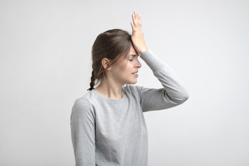 Fototapeta premium young stressed caucasian woman touching her forehead in pain.