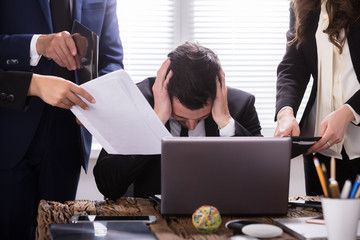 Stressed Businessman Sitting In Office
