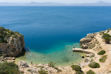 Blue crystal waters at a small beach near archaeological site of Heraion, sanctuary of goddess Hera, in Perachora, Loutraki, Greece