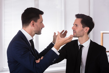 Angry Businessman Holding His Partner's Tie