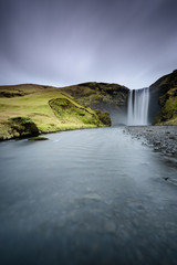 Fototapeta na wymiar Beautiful Skogafoss. Amazing landscape at sunset in the most popular waterfall in Iceland. Long exposure effect. Dawn in the ring road.
