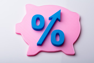 Blue Percentage Symbol Over Pink Piggybank