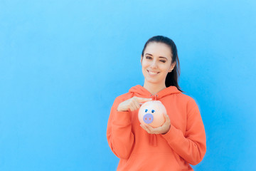 Girl Checking Piggy Bank for Money Savings 