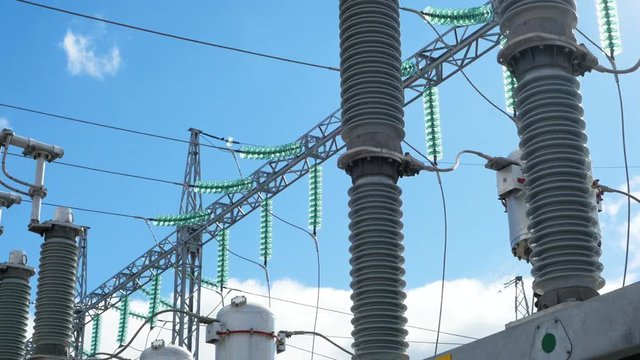 modern transformer with glass insulators against blue sky