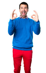 Fototapeta premium Handsome young man making OK sign on white background