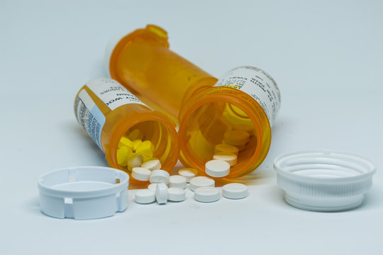 Oxycodone pills spilled out of perscription containers