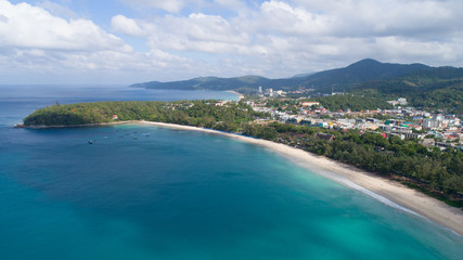 Kata beach, Phuket, Thailand. January, 2018. Aerial shot in the morning above the beach and sea with many tourist and boats.