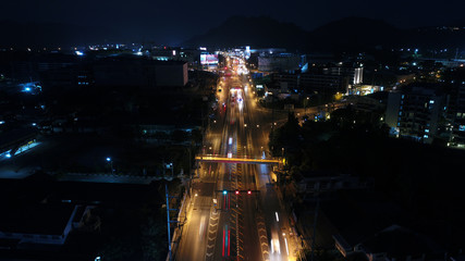 At night. In december, 2017. The main intersection in Phuket town with many vehicles. this intersection has a tunnel to go under the intersection. and surround with department store and apartments.