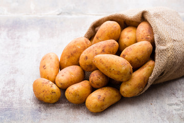 A bio russet potato wooden vintage background.