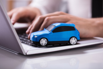 Blue Car On Laptop Keypad