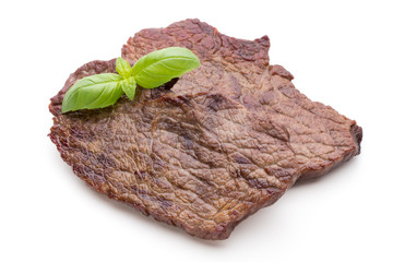 Grilled beef steaks with spices isolated on white background.