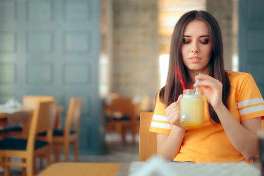 Woman in a Restaurant Drinking Lemonade Citrus Fruit Juice