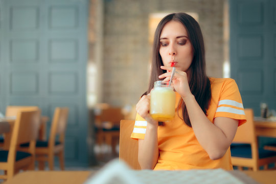Woman in a Restaurant Drinking Lemonade Citrus Fruit Juice