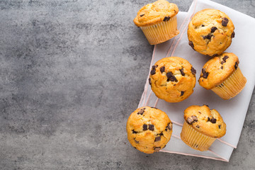 Homemade chocolate muffins on the vintage background.