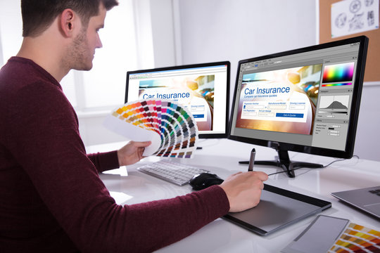 Designer Working On Multiple Computer Screens
