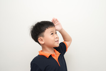 Cute little boy showing a saluting gesture in the studio