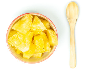 Pineapple in bowl on white background.