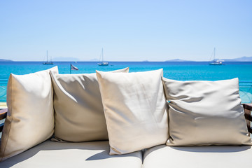 Resort, Greece, Kos Island, Kefalos: relaxing by the sea on a cozy couch with little pillows right...