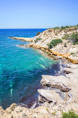 Beach, Greece - Kos Island, Kefalos: Picturesque deep blue Caribbean Bay with wild sea of ​​Greek Agais and steep sandstone cliffs, perfect for wind surfers with heavy waves