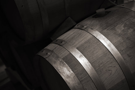 Wooden Barrel With Red Wine In Dark Winery