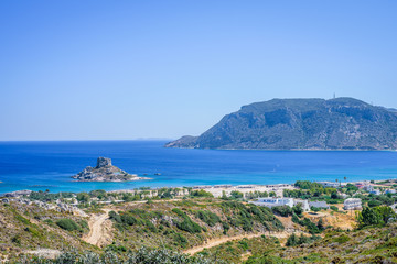 Fototapeta na wymiar Overview over the bay of Kefalos and the small island of Kastri on a sunny day, Kos Island, Greece