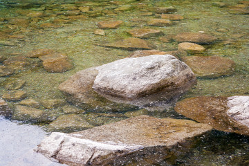 boulders and stones covered with transparent water in 'Morskie Oko' in Poland