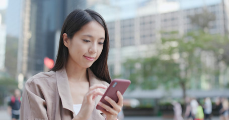 Woman use of smart phone in city