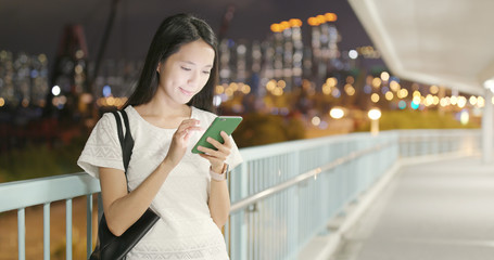 Woman use of mobile phone at night