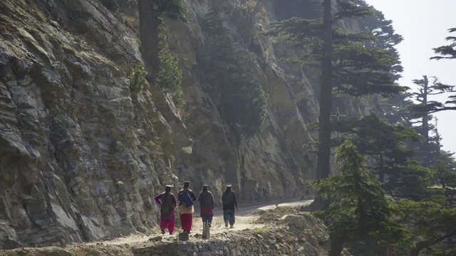 way to Kalpa village,back view people walking on the road through rocky mountain