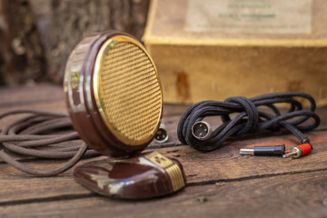 Close up shot of a antique 50s microphone with cables and box, vintage styleconcept.