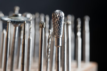 milling heads on a goldsmith workplace, macro shot of  jewelry tools against a dark background