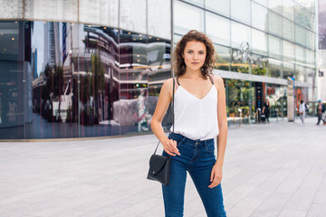 Pretty girl standing next to the modern bulding(horizontal)