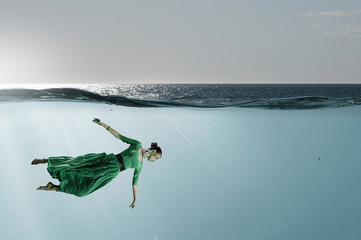 Woman dancer in clear blue water