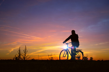 Fototapeta na wymiar Man silhouette drive on bicycle