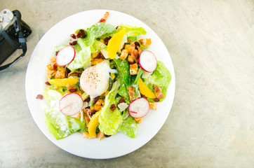 Fresh healthy in top view is a caesar salad with egg on the table.