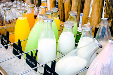Bottle of fresh Juice and milk buffet self service in morning at hotel.