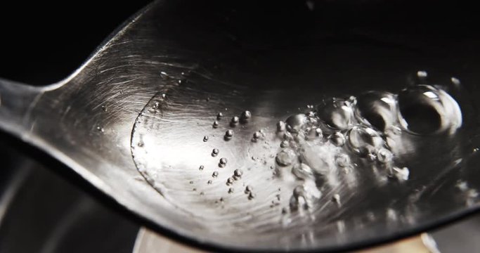 Top view of cooking Heroin on spoon