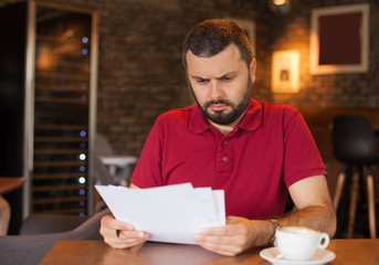 Worried man reading a document