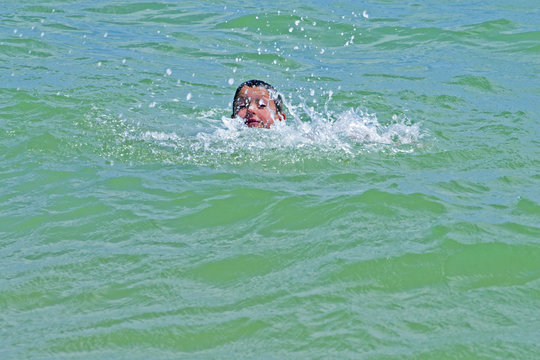 boy is swimming in the ocean