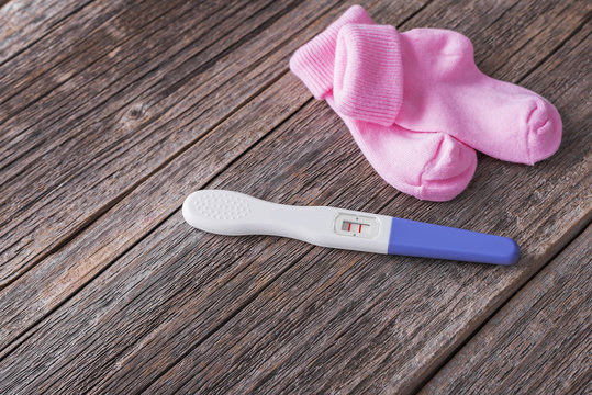 Pregnancy test and baby socks.